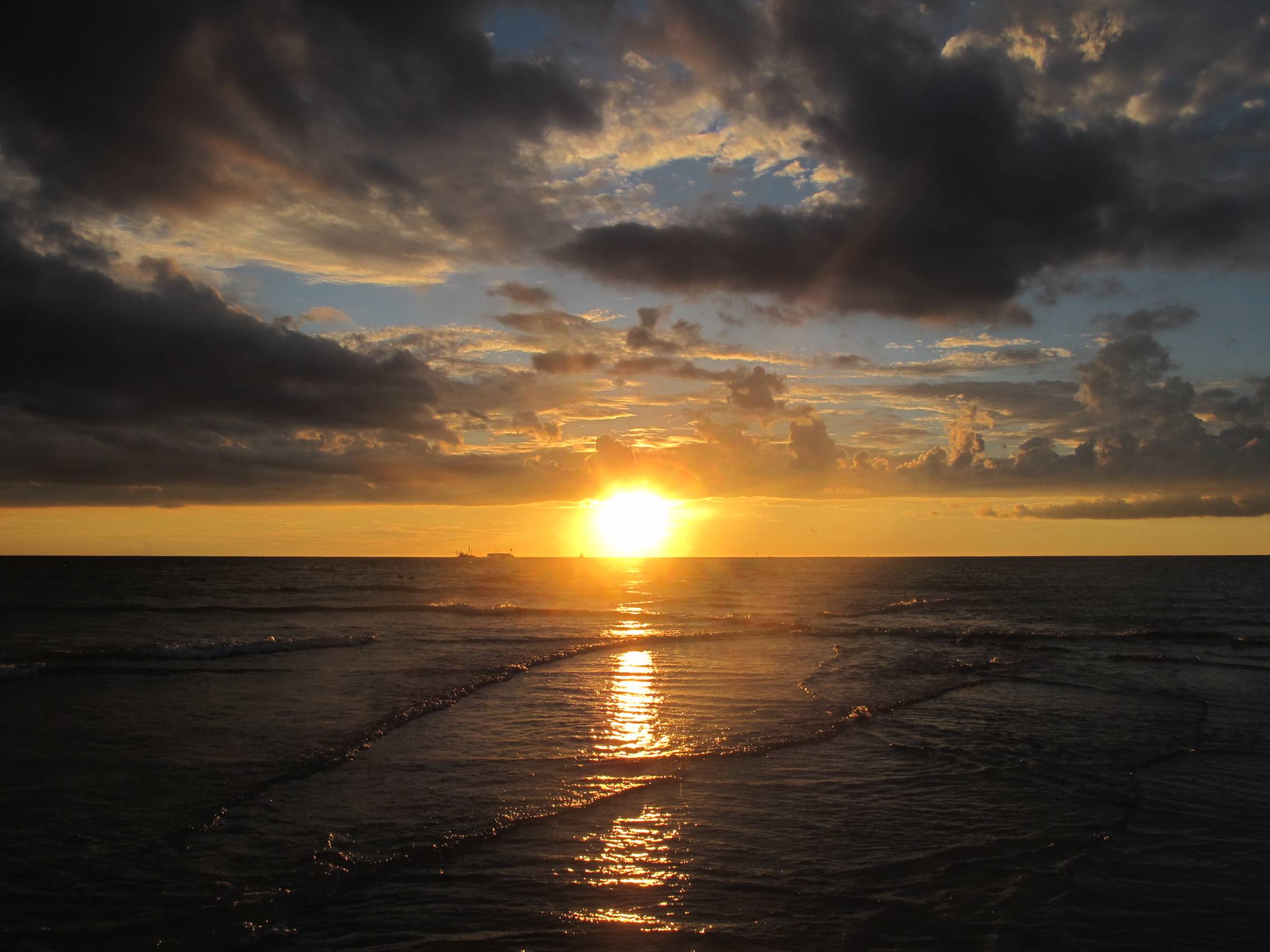 Sun peeking through clouds on TI.